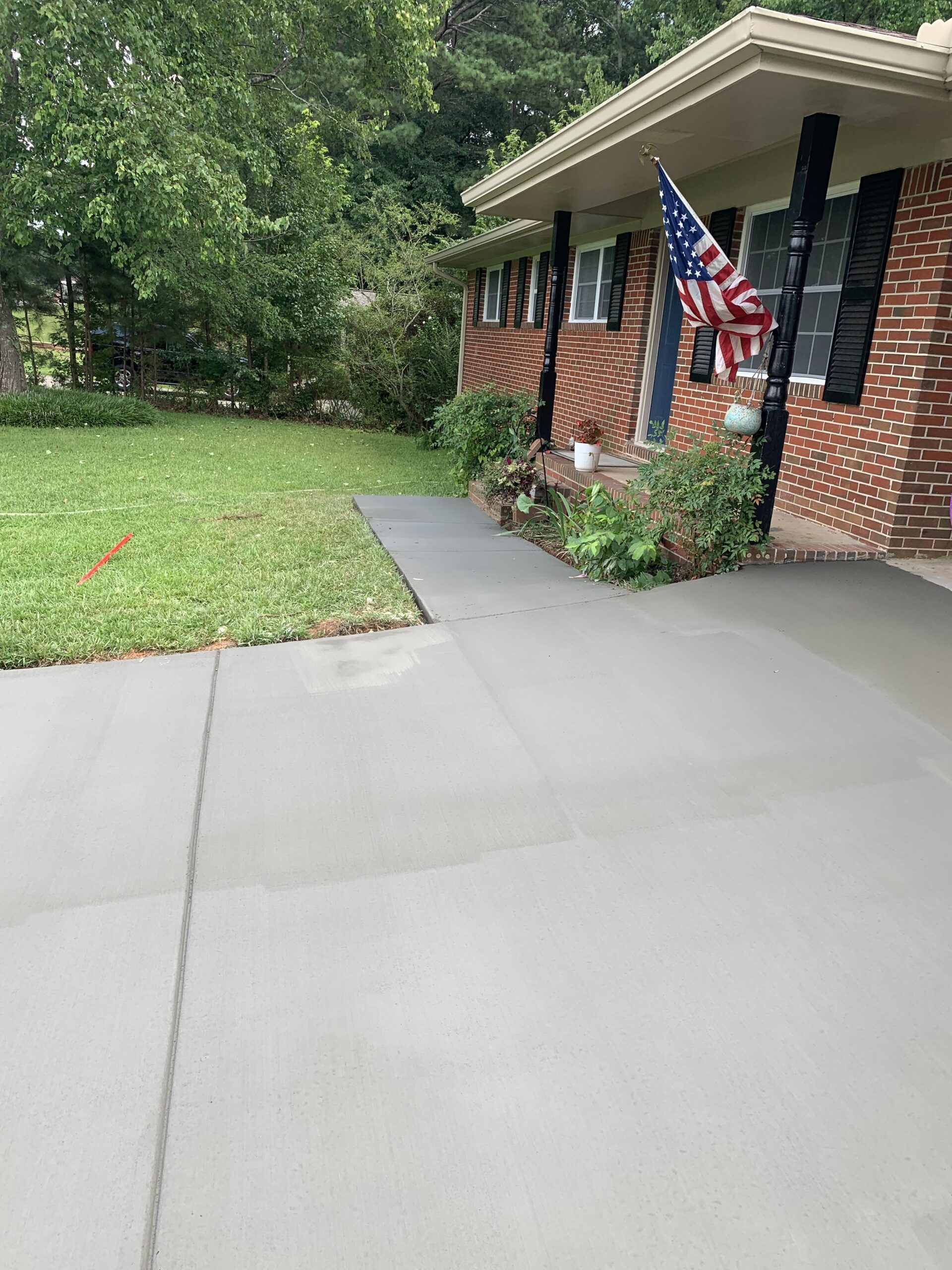 A freshly poured concrete driveway and walkway.