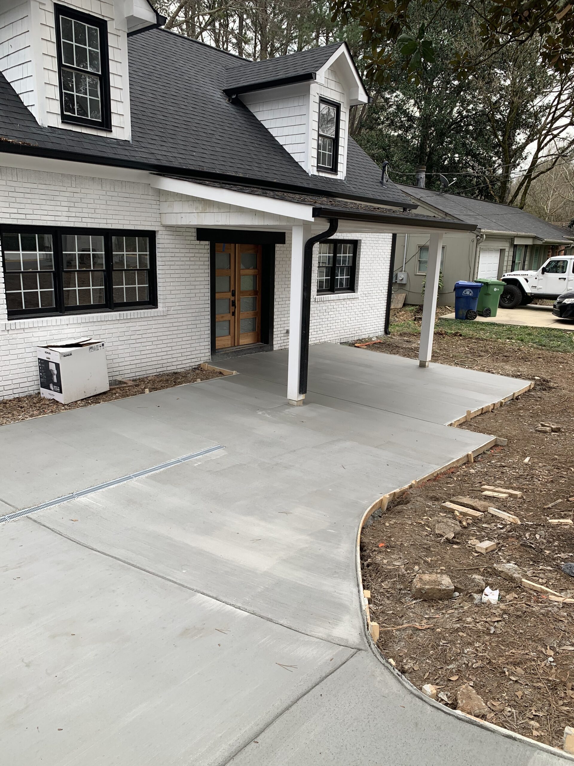 A freshly poured concrete driveway.